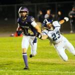 Sequim Gazette photo by Michael Dashiell Sequims Zeke Schmadeke, left, races away from North Mason defender Caden Atencio in the Wolves 36-0 Homecoming victory on Oct. 13.