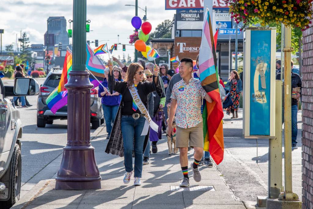 Sequim Gazette photo by Emily Matthiessen
Sequims second annual Pride march and celebration took place in June. Grand Marshal Lorie Fazio and Pride committee volunteer David Ham lead the march up and down Washington Street with a happy crowd behind them.