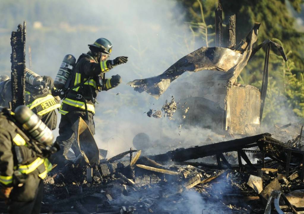 Sequim Gazette photo by Michael Dashiell
Firefighters with Clallam County Fire District 3 respond to a home explosion and fire on the 100 block of June Place on July 18 that took the life of a Sequim man.