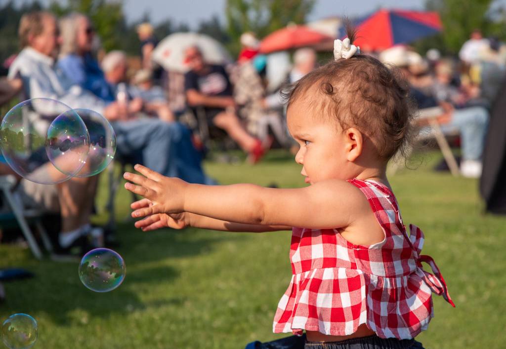 Sequim Gazette photo by Emily Matthiessen / Ember Johnson, 16-months-old, enjoys the bubbles at Sequims Independence Day celebration.
