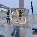 Photo by Jay Cline/Clallam County Fire District 2 / Firefighters from Clallam 2 Fire-Rescue and the Port Angeles Fire Department remove a door from the remains of the Olympic National Park Day Lodge on May 7.