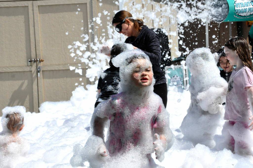Sequim Gazette photo by Matthew Nash/ Six-year-old Lyla Huffman of Sequim plays in the foam during the Irrigation Festivals Family Fun Days in May. Her mom said she was having a blast. Local business Strait Up Foam Fun came to Carrie Blake Community Park to offer children and adults the chance to play in the eco-friendly, biodegradable foam for hours.