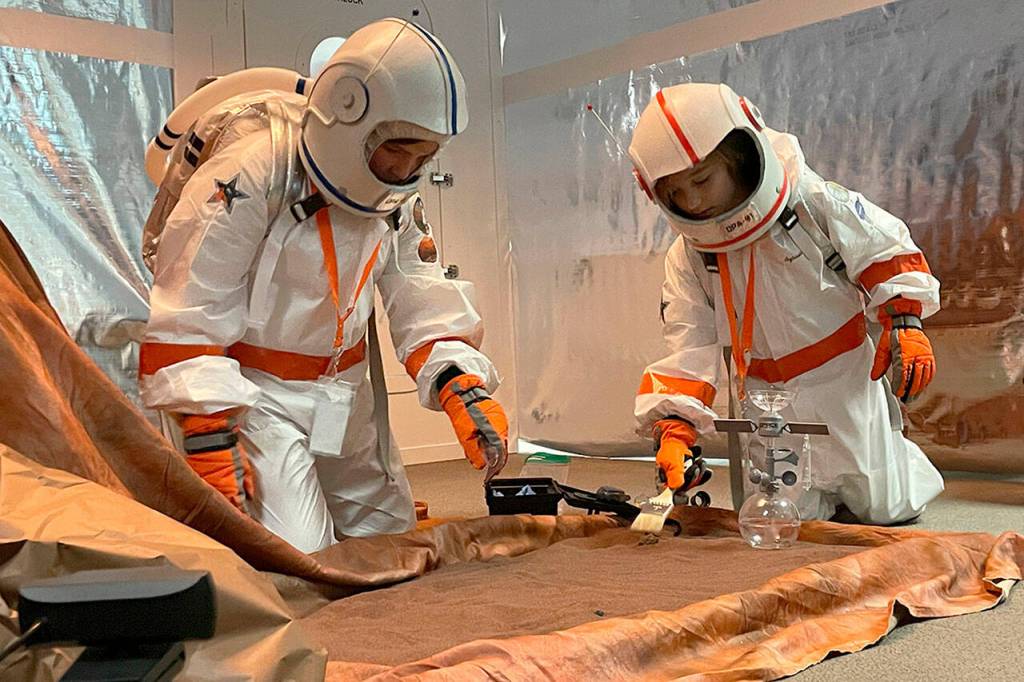 Sequim Gazette photo by Matthew Nash/ Third-grade geologists Atreus Parker and Zische Sylvester at Olympic Peninsula Academy go onto Mars in Michele Canepas class to uncover rock specimens during an interactive lesson in March.