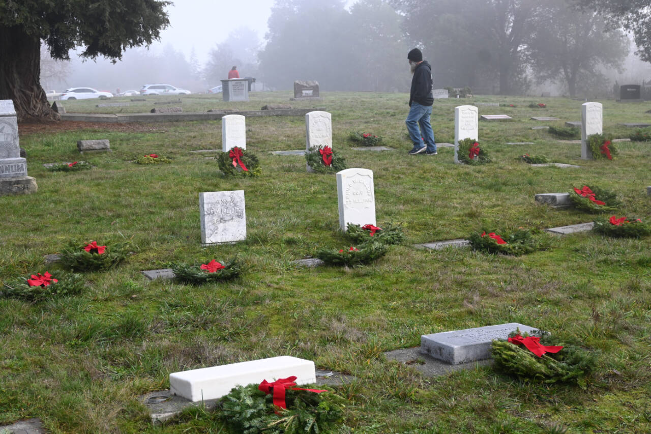 Sequim Gazette photo by Michael Dashiell / Dozens of community members turn out to place balsam wreaths on grave markers at Sequim View Cemetery on Dec. 16. Organizers of local Wreaths Across American events re seeking volunteers to help gather and recycle the wreaths at Sequim and Port Angeles locations this week.
