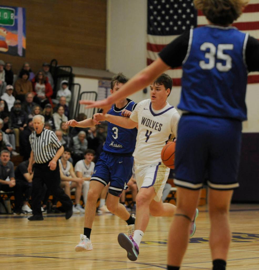 Sequim Gazette photo by Michael Dashiell
Sequims Keenan Green, center, drives past North Masons Cameron Revelez in the first half of SHSs 70-56 home win on Jan. 2. Looking on is North Masons Derek Dunham (35).