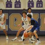 Sequim Gazette photo by Michael Dashiell / Sequims Garrett Little (5) and SHS teammates defend the basket as North Masons Cameron Revelez looks to score in the first half of Sequims 70-56 win on Jan. 2.