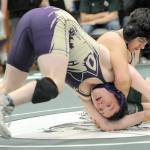 Photo by Keith Thorpe/Olympic Peninsula News Group / Sequims Roger Burwash, front, struggles to keep on his feet against Port Angeles Oliver Martinez in the 165-pound division at the Battle for the Axe on Jan. 6 in Port Angeles.