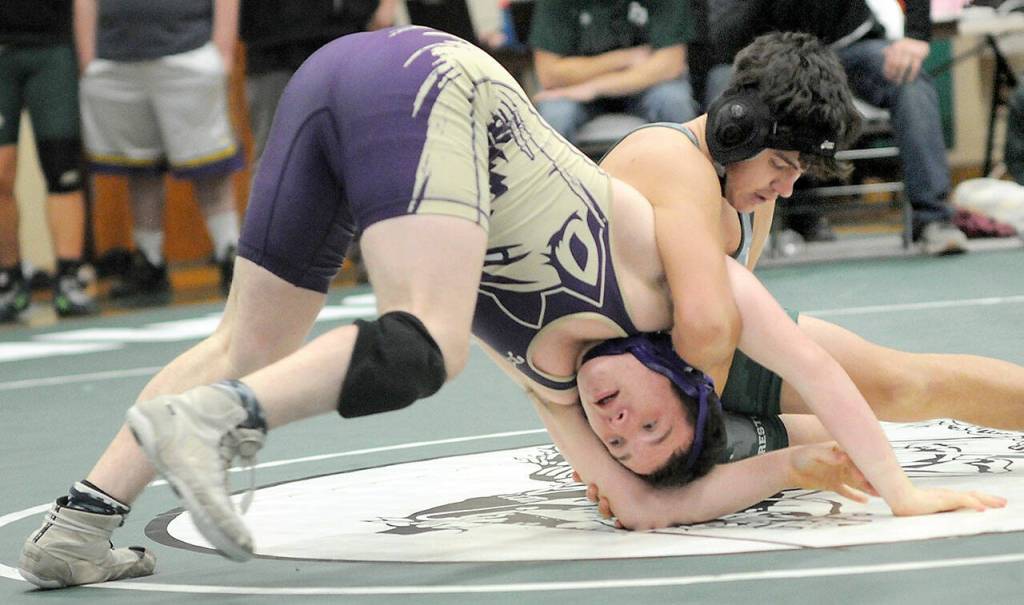 Photo by Keith Thorpe/Olympic Peninsula News Group / Sequims Roger Burwash, front, struggles to keep on his feet against Port Angeles Oliver Martinez in the 165-pound division at the Battle for the Axe on Jan. 6 in Port Angeles.