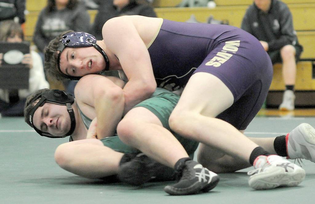 Photo by Keith Thorpe/Olympic Peninsula News Group / Sequims Dylan Bowen, top, tries to contain Port Angeles Hunter Blore in the 190-pound category at the Battle of the Axe tournament at Port Angeles High School on Jan. 6.