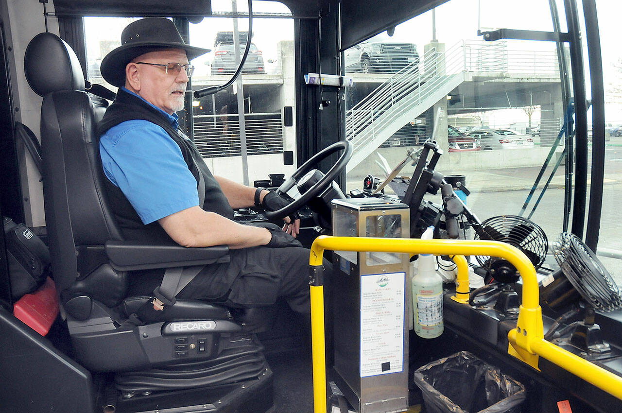 Photo by Keith Thorpe/Olympic Peninsula News Group
Clallam Transit driver Duane Benedict looks down at his fare box before departing The Gateway transit center in downtown Port Angeles on Dec. 30  the last day of collecting fares on most bus routes.