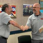 Photo courtesy Clallam County Fire District 3
Fire commissioner Bill Miano, right, shakes the hand of new commissioner Mike Mingee after swearing him in with an oath of office on Jan. 2. Mingee was elected to a six-year term in Novembers General Election.