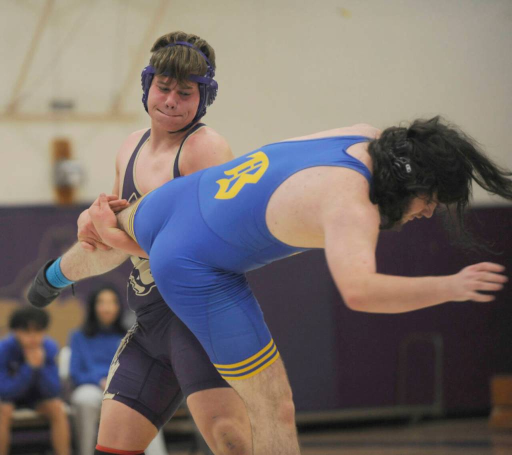 Sequim Gazette photo by Michael Dashiell
Sequims John Prorok, left, takes down Bremertons Cole Sanford in the 215-pound weight class of an Olympic League match on Jan. 10. in Sequim.