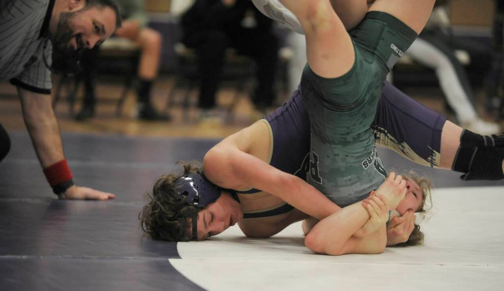 Sequim Gazette photo by Michael Dashiell / Sequims Ryan Spelker, left, works to pin Port Angeles Faye Dachs in the 120-pound weight class in an Olympic League match in Sequim on Jan. 10.
