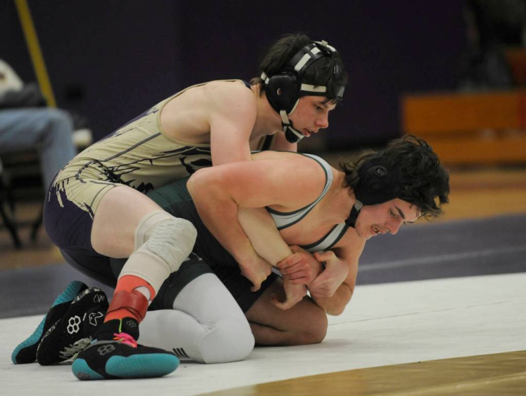 Sequim Gazette photo by Michael Dashiell / Sequims Johnny Vilona, left, wrestles Port Angeles Cash Coleman in the 126-pound weight class of an Olympic League match on Jan. 10.