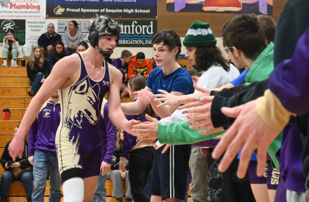 Sequim Gazette photo by Michael Dashiell / Sequims Jayms Vilona gets congratulated by teammates after a win over his Bremerton foe on Jan. 10.