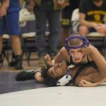 Sequim Gazette photo by Michael Dashiell / Sequims Brandon Bair, top, grapples with Bremertons Makhi Marion at 10-6 pounds. Bairs come-from-behind pin in the matchs final individual pairing helped Sequim win by five points.