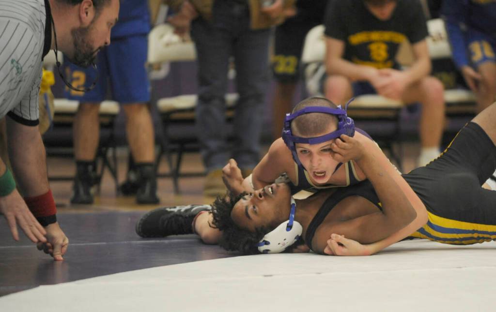 Sequim Gazette photo by Michael Dashiell / Sequims Brandon Bair, top, grapples with Bremertons Makhi Marion at 10-6 pounds. Bairs come-from-behind pin in the matchs final individual pairing helped Sequim win by five points.
