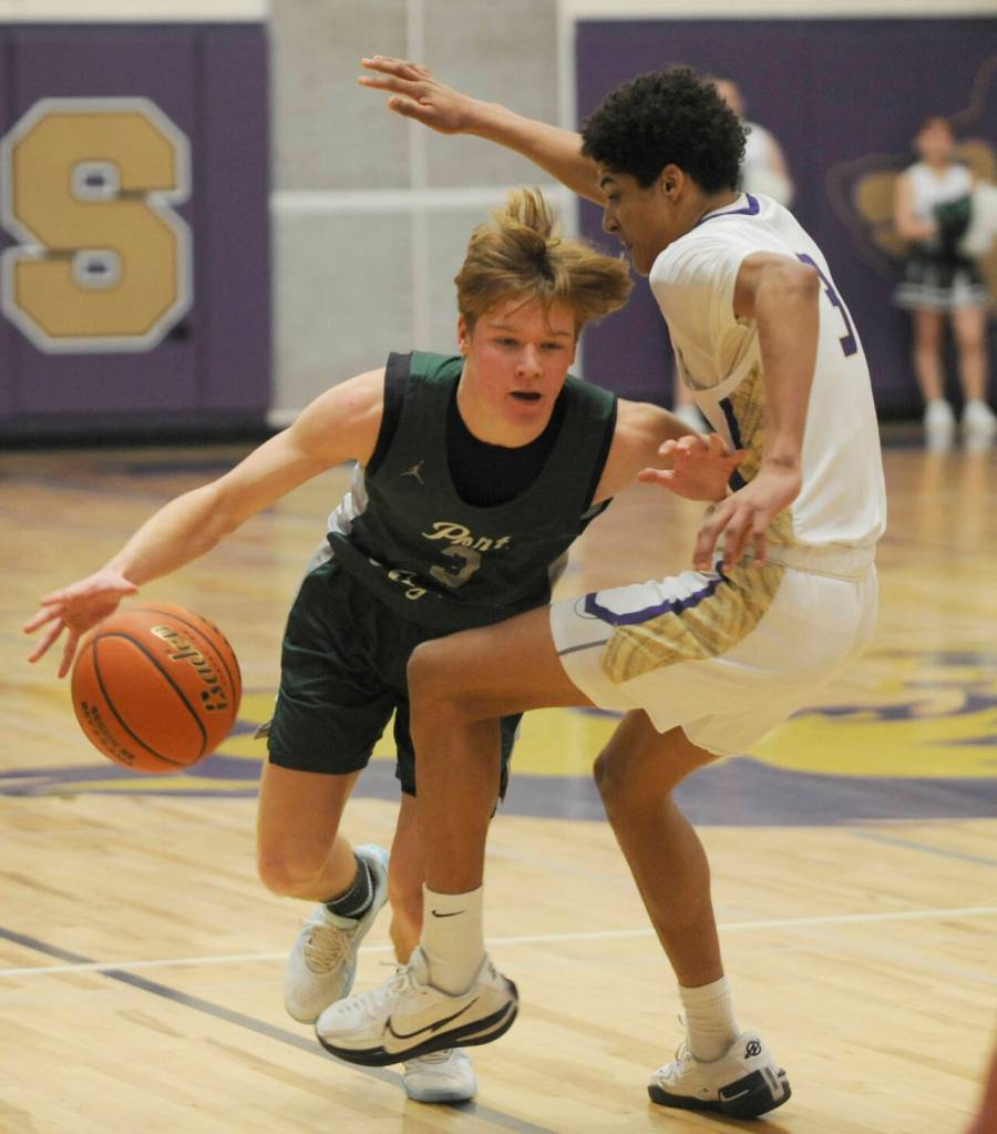 Sequim Gazette photo by Michael Dashiell / Sequims Solomon Sheppard, right, pressures Gus Halberg in the first half of a Jan. 11 Olympic League match-up.