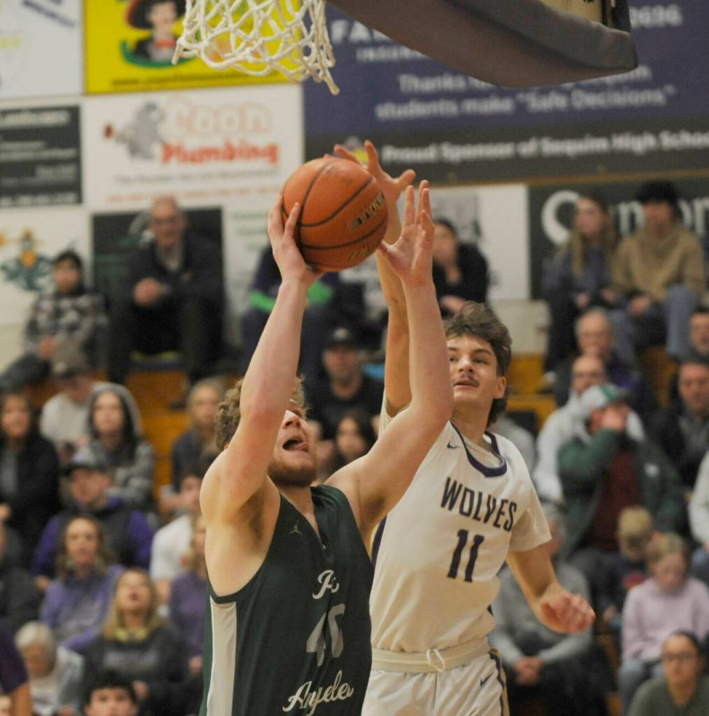 Sequim Gazette photo by Michael Dashiell / Sequims Charlie Grider, Right battles for a rebound with Port Angeles post Isaiah Shamp in a Jan. 11 Olympic League match-up in Sequim.