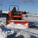 Sequim Gazette photo by Michael Dashiell / Dale Jung clears the Sequim School District stadium parking lot on jan 12, following a snowfall last week.