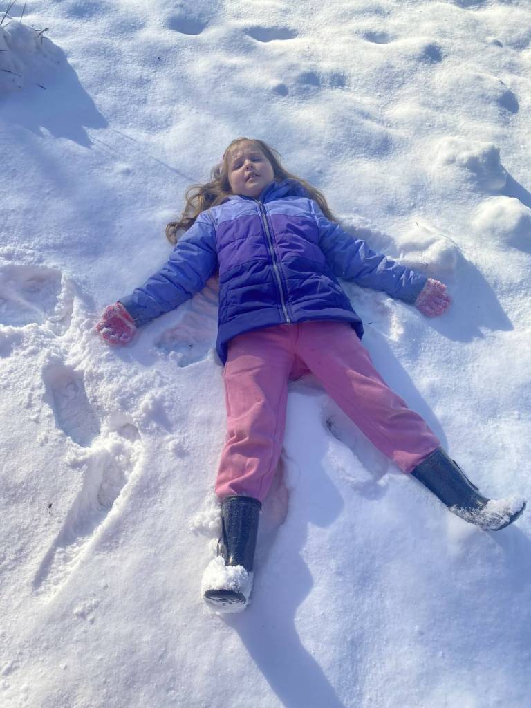 Photo by Emily Coler / Nearly-7-year-old Paisley works on her snow angel on Friday, Jan. 12.