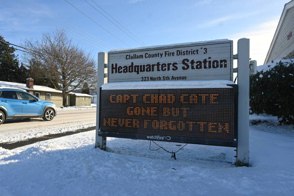 Sequim Gazette photo by Michael Dashiell/ Snow partially covers the readerboard outside the Clallam County Fire District 3 station on north Fifth Avenue. Friday, Jan. 12, marked the one-year anniversary of the passing of Capt. Charles (Chad) Cate, who died while on duty.