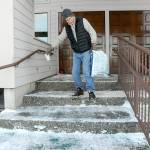 Photo by Keith Thorpe/Olympic Peninsula News Group / Darryl Wood of Port Angeles makes his way down icy steps at Bethany Pentecostal Church in Port Angeles after shoveling snow and spreading an ice-melting agent on Jan. 12.