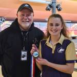 Sequims Nikoline Updike celebrates her Olympic League championship on Jan. 18 with SHS head coach Randy Perry.