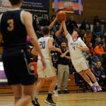 Sequim Gazette photos by Michael Dashiell 
Above: As teammate Mason Rapelje (20) and SHS coach Craig Brooks (background) look on, Sequims Keenan Green tries to deflect the ball from a Bainbridge defender in an Olympic League match-up in Sequim on Jan. 20.