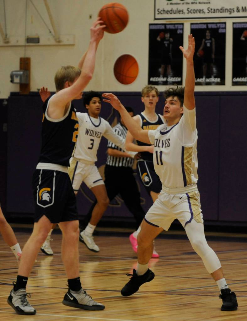 Sequim Gazette photo by Michael Dashiell / Sequims Charlie Grider, right, guards the basket agains Bainbridges Evan Burke in the Wolves loss to the 3A Spartans on Jan. 20.