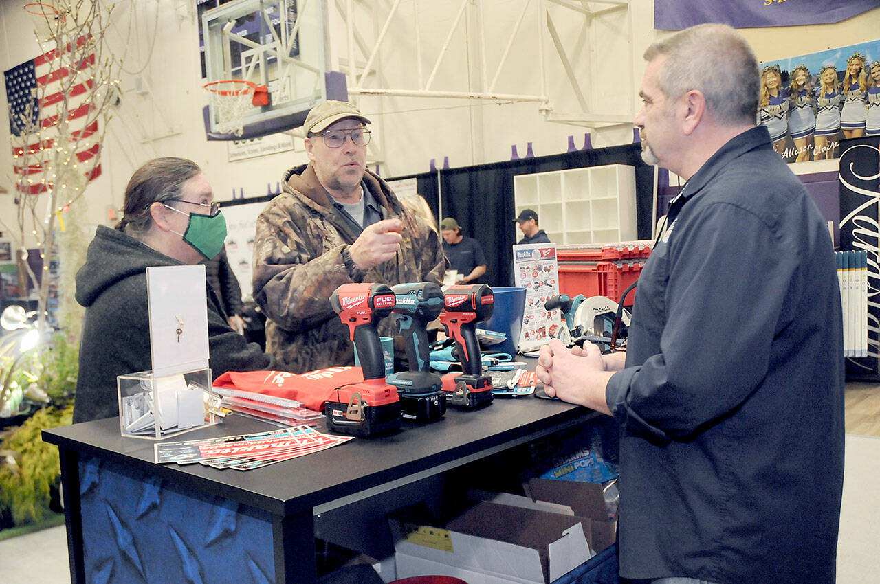 File photo by Keith Thorpe/Olympic Peninsula News Group
Jack and Marcella Ridge of Sequim talk about power tools with Tony Contestable, tool specialist with Hartnagel Building Supply of Port Angeles, right, at the North Peninsula Building Associations Building, Remodeling & Energy Expo in 2023. This years event is set for Feb. 3-4 at the Sequim Middle School.