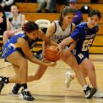 Sequim Gazette photo by Matthew Nash / Sequims Raimey Brewer, center, tries to keep the ball from a pair of Bremerton defenders in a 70-41 Sequim home win on Jan. 19.