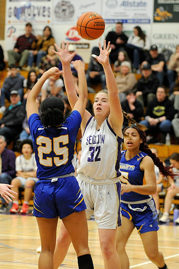 Sequims Hailey Wagner, center, defends the basket in a Jan. 19 Olympic League game against Bremerton. Wagner had five rebounds in a 70-41 SHS win.