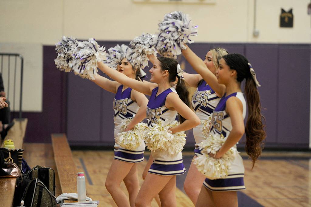 Sequim Gazette photo by Matthew Nash/ Sequim cheerleaders encourage audience members on Jan. 26 at home against North Mason.