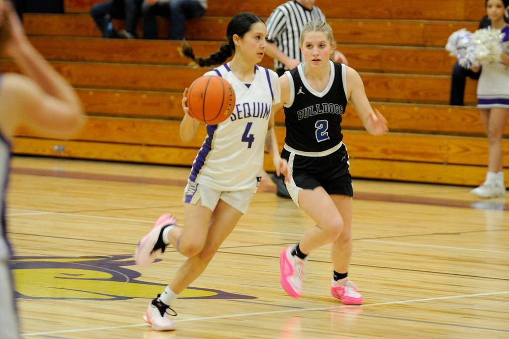 Sequim Gazette photo by Matthew Nash/ Sequims Gracie Chartraw (4) drives Clara Galbraith (2) in a close 73-66 Sequim home win on Jan. 26 over North Mason.