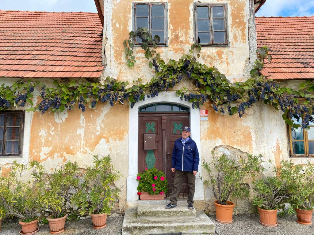 Photo courtesy of Steve Nordwell / Anton Blašič stands outside the home of Frančišec Blašič, his father and an eyewitness to the 1944 B-24 crash.