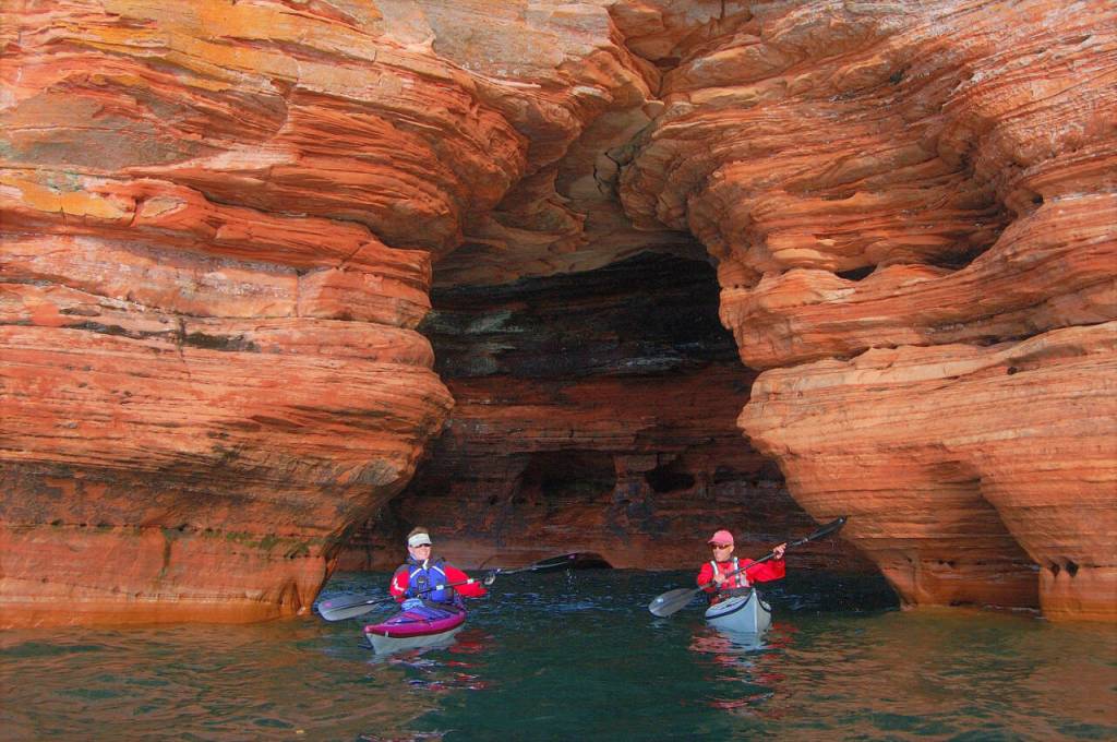Photos courtesy of Gail Green and Grant Herman
Kayakers paddle under a sea cave arch on Lake Superiors Apostle Islands.