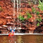 Photo courtesy of Gail Green and Grant Herman / A kayaker enjoys a waterfall off one of the Apostle Islands.