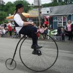 Photo courtesy of Tony and Jen Burgess / Tony and Jen Burgess offer their thoughts on a memorable trip from Quebec City to Halifax in Quebec and the Maritimes by tandem, a 2024 Travelers Journal Series event on March 21. Pictured here is the old way of cycling during a Canada Day Parade in Sherbrooke, Nova Scotia.