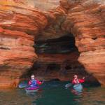 Photo courtesy of Gail Green and Grant Herman
Kayakers paddle under a sea cave arch on Lake Superiors Apostle Islands. Join Gail Green and Grant Herman for their 2024 Travelers Journal Series presentation, Jewel of Lake Superior: The Apostle Islands National Lakeshore, on Feb. 15.
