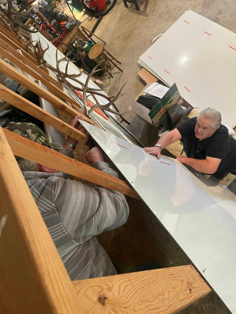 Photo courtesy of Melissa Klein / Carl Bradshaw, right, and fellow American Legion members help cut and shape pieces of alupanels to be attached to the Posts building as part of a mural. Artist Melissa Klein said she hopes to have it finished by Sequim Irrigation Festival weekends in May.