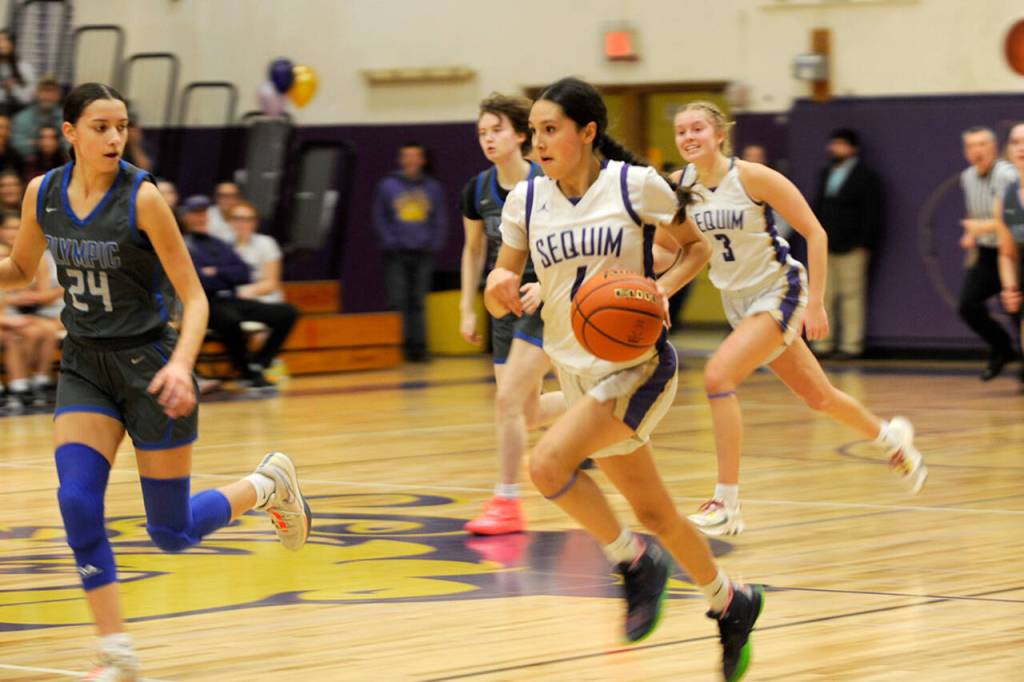 Sequim Gazette photos by Matthew Nash
Sequim guard Gracie Chartraw pushes it up court against Olympic players on Feb. 1.