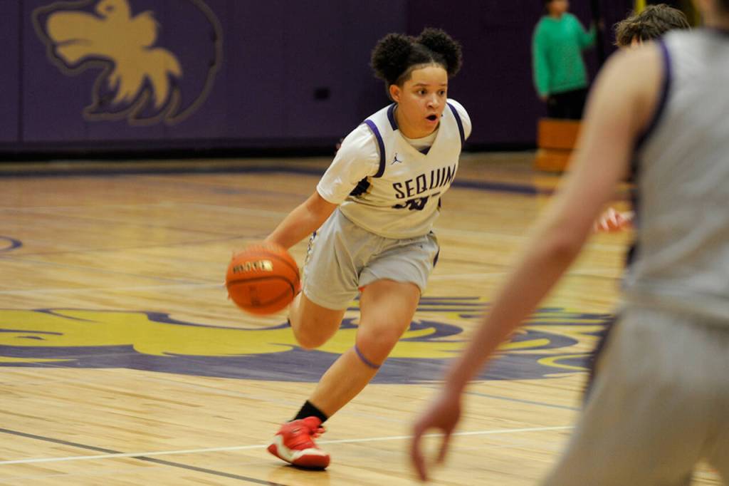 Sequim Gazette photo by Matthew Nash/ Gracie Chartraw drives against Olympic players on Feb. 1.