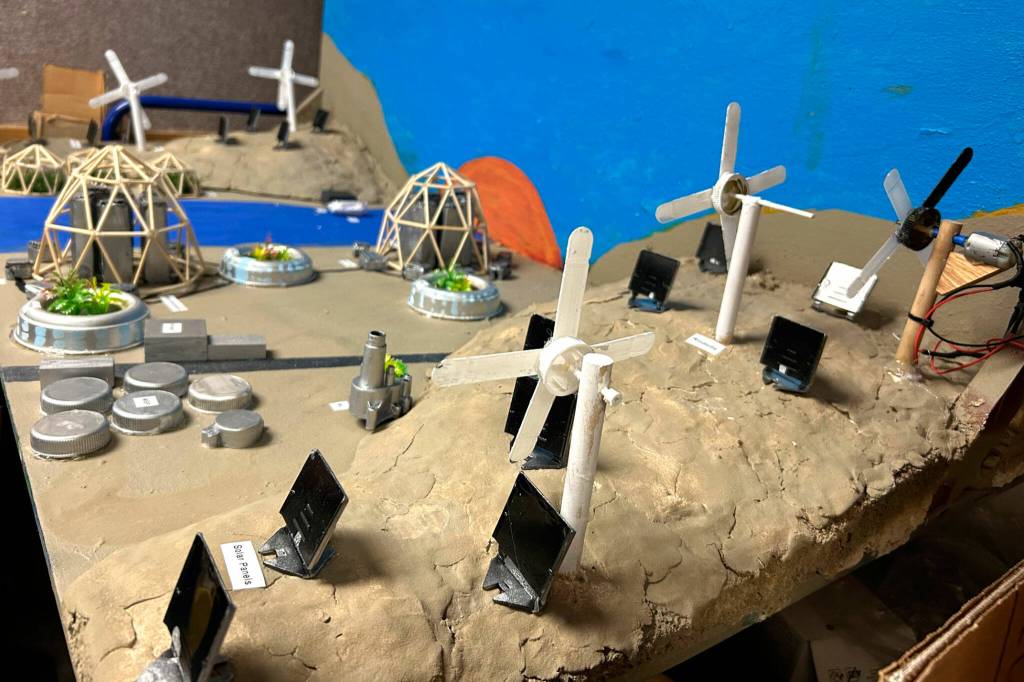 Sequim Gazette photo by Matthew Nash/ Team Ramaal Hara of Brayden Baritelle, Shay Lucier and Rivers Maynard featured a repurposed R/C car turned into a fan and lights for their desert Future City.