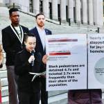 Photo courtesy of Washington State Journal / Taking their arguments on jaywalking to the steps of the Capitol in Olympia are, from left in the back row: Sen. Rebecca Saldana, community member DeAndre Anderson, Advocacy Director at Transportation Choices Matthew Sutherland, holding microphone, and research partner Ethan C. Campbell,on Jan. 23. Transportation Choices held a press conference on the north steps of the Washington State Capitol to unveil a new research report that shows disparate impacts of jaywalking enforcement.