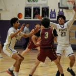 Sequim Gazette photo by Michael Dashiell / Sequim's Solomon Sheppard, left, and Jericho Julmist, right guard Kingston's Jace Brady in a 63-50 Wolves win on Jan. 26.