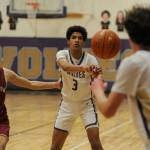 Sequim Gazette photo by Michael Dashiell / Sequim's Solomon Sheppard, center, passes to teammate Garrett Little as Kingston's xxxxxx (1) guards the play in a 63-50 win over the Buccaneers on Jan. 26.