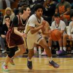 Sequim Gazette photo by Michael Dashiell / Sequim's Solomon Sheppard, right, looks to drive past Kingston's Ibrahim Trawally in the fourth quarter of a 63-50 Wolves win on Jan. 26.