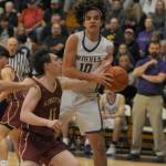 Sequim Gazette photo by Michael Dashiell / With Sequim coach Craig Brooks, right, looking on, Sequim's Lars Wiker snags an offensive rebound as Kingston's Dewaun Swan (11) guards the play in the Wolves' 63-50 win over the Buccaneers on Jan. 26.