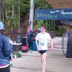 Photo by Pierre LaBossiere/Olympic Peninsula News Group / Mens 5k winner Langdon Larson of Port Angeles crosses the finish line at the Elwha Bridge Run on Feb. 3.